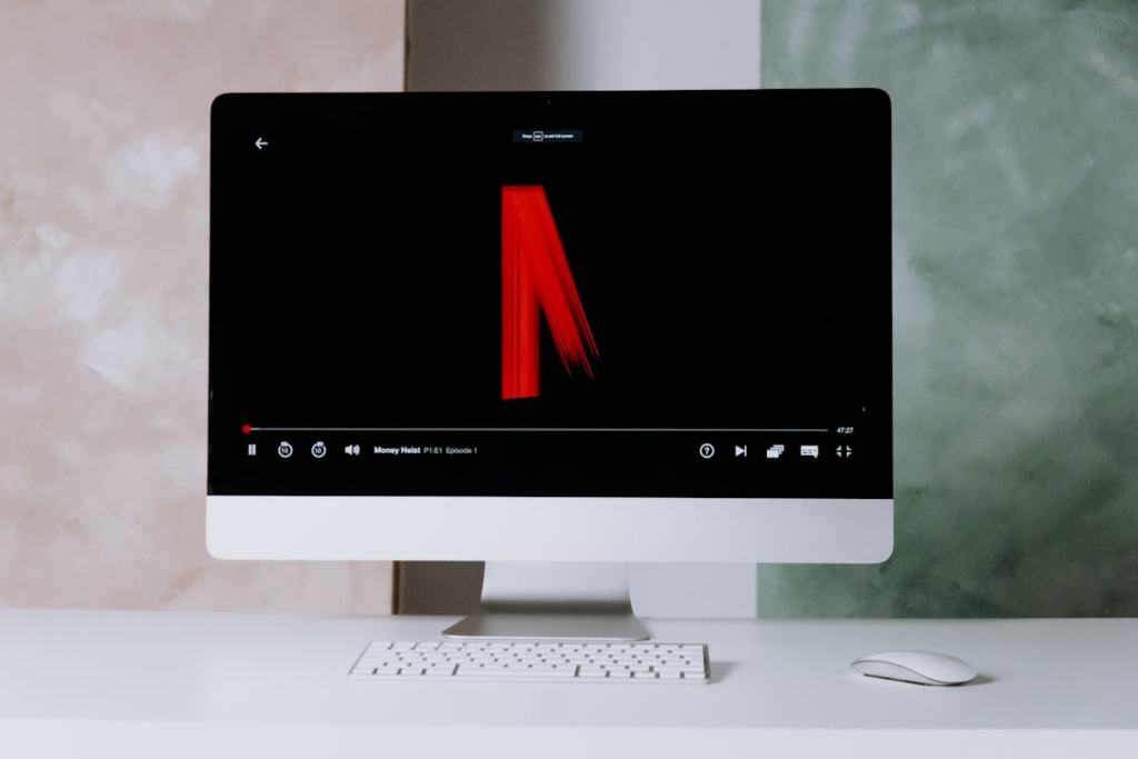 Netflix plays on a desktop illustrating ad-supported vs ad-free streaming comparison.