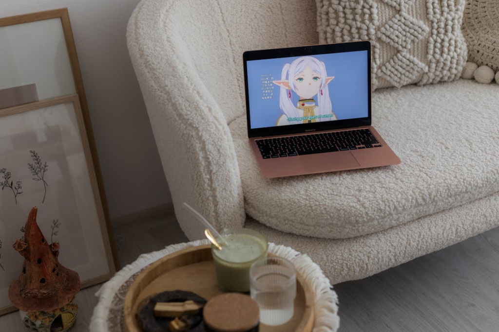 Anime plays on a laptop to illustrate Crunchyroll vs Netflix for anime streaming.