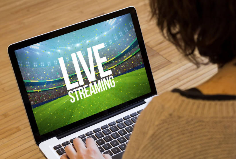 Viewer comparing Hulu Live vs YouTube TV for live sports streaming on a laptop.