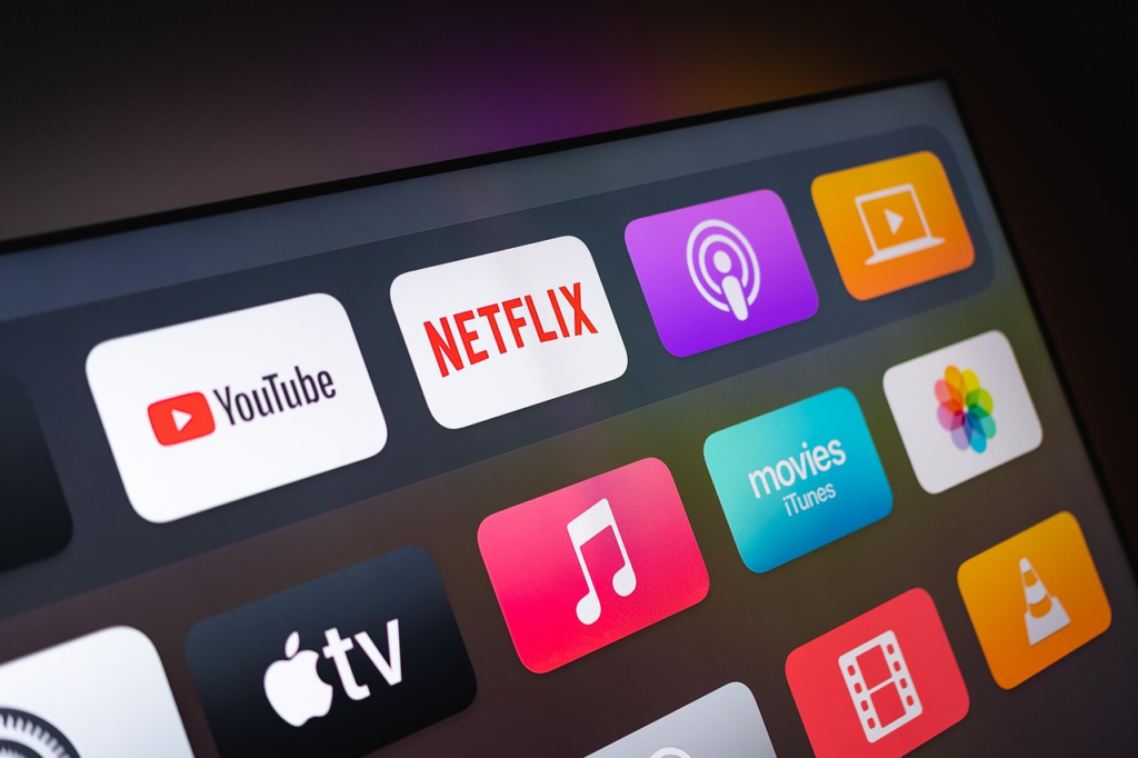 TV screen showing premium entertainment bundles across Netflix, YouTube, Apple TV, and other streaming apps.
