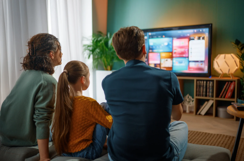 Family comparing Sling Orange vs Blue packages for shared live TV viewing at home.
